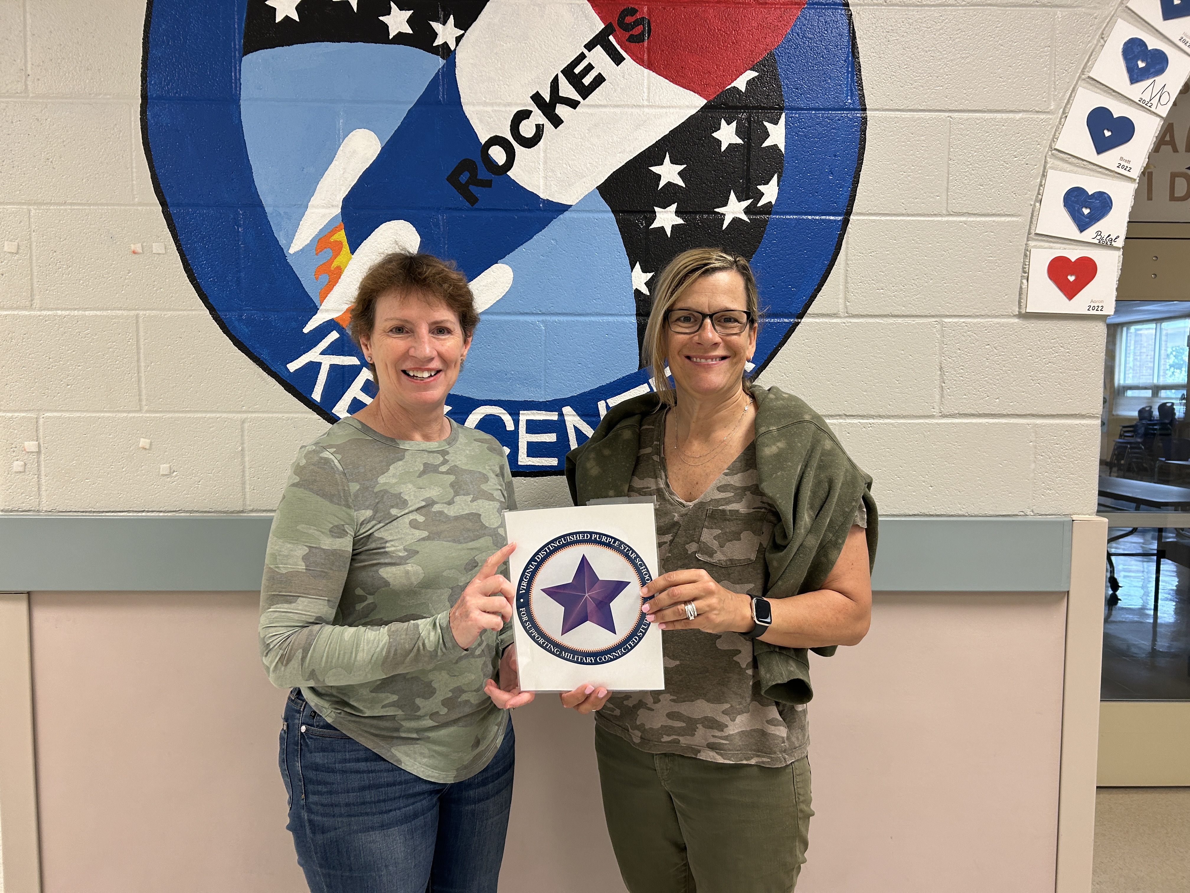 two administrators in camo with a purple star