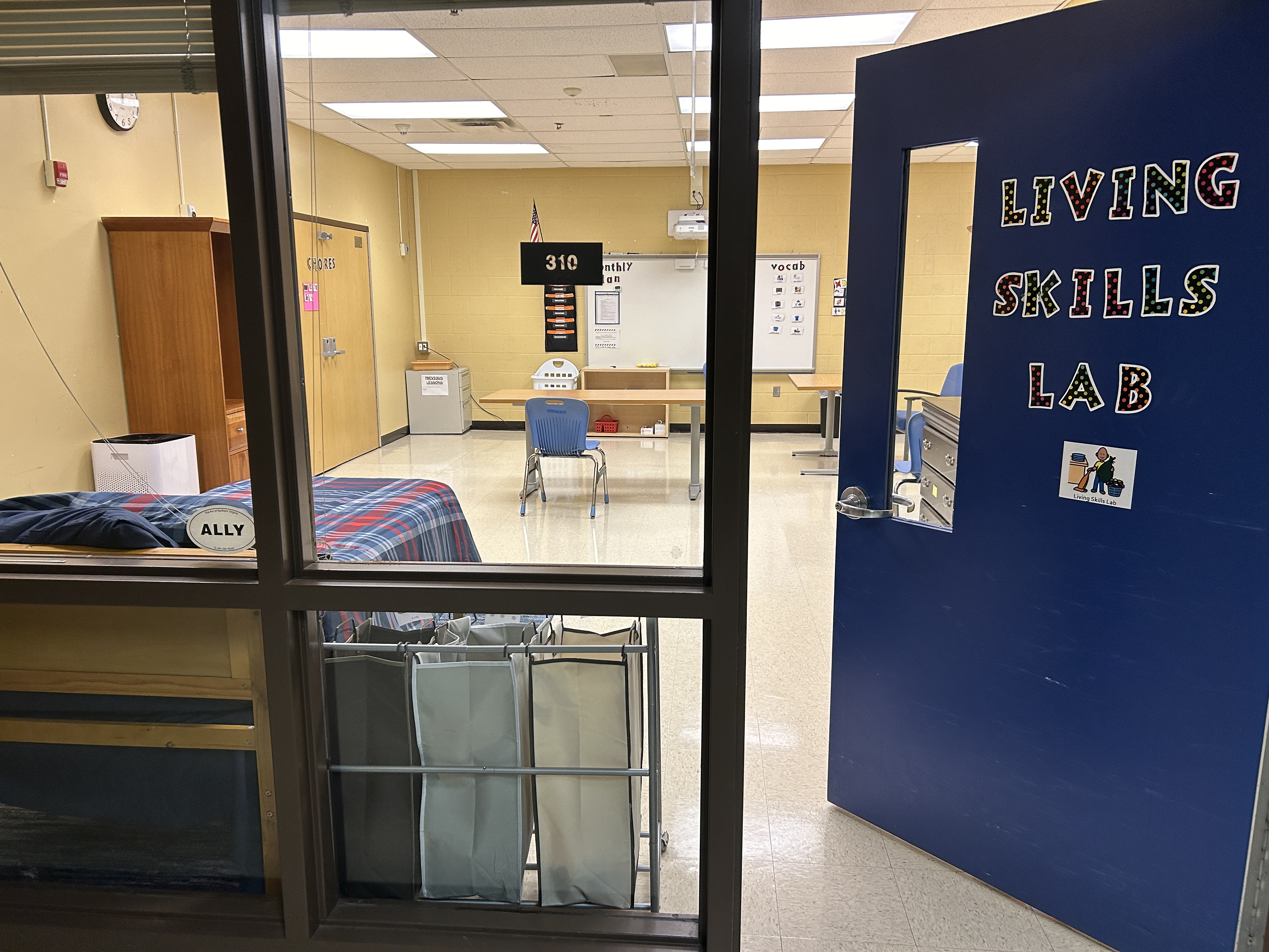 an open door showing a room called a living Skills Lab