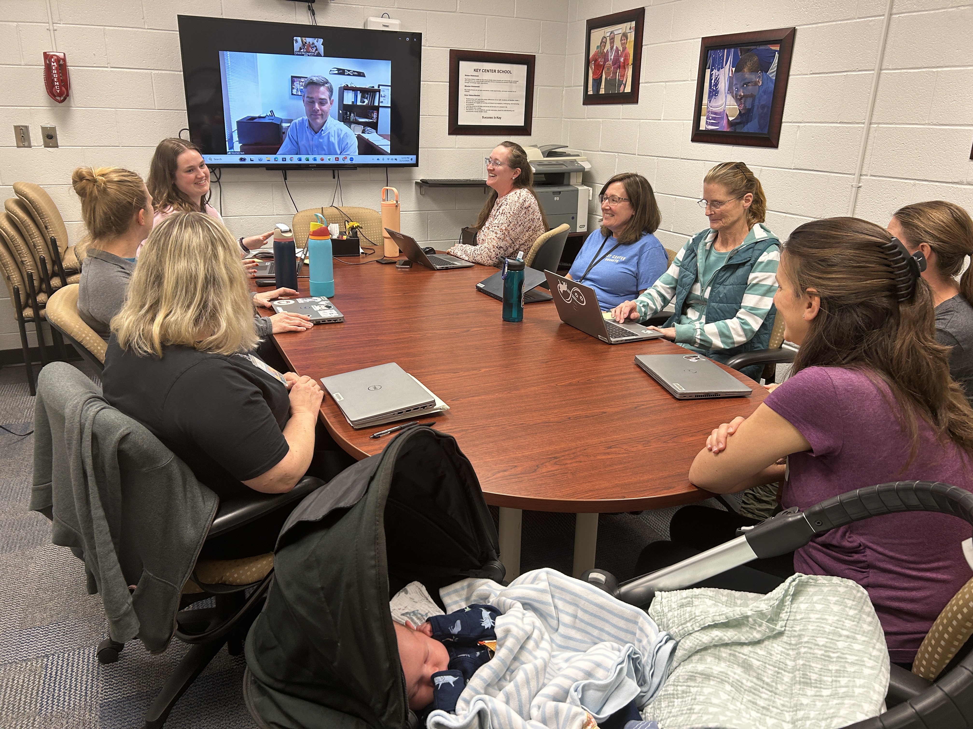 staff and family in meeting