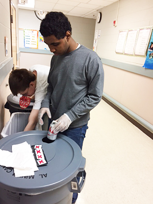 Two students sorting for recycling