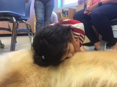 Student laying head on dog